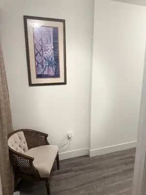 a room with a chair and a picture on the wall at LuxSpace Properties in London