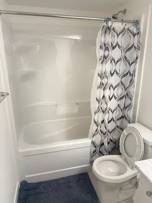 a bathroom with a toilet and a shower curtain at LuxSpace Properties in London