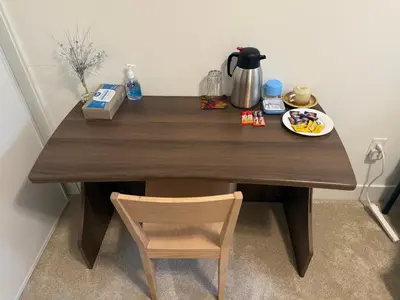a wooden table with a plate of food on it at LuxSpace Properties in London