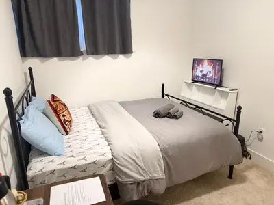 a bedroom with a bed with a tv on the wall at LuxSpace Properties in London