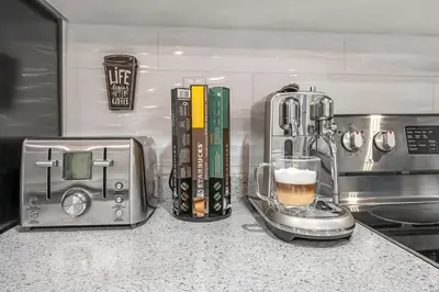 a kitchen counter with a coffee maker and a blender at Family-Friendly 2BR Ground-Level Suite with Full Kitchen, Parking and 20 Minutes to Downtown in Toronto