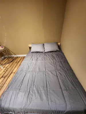 a bed in a corner of a room at The Cozy Den in Ingersoll