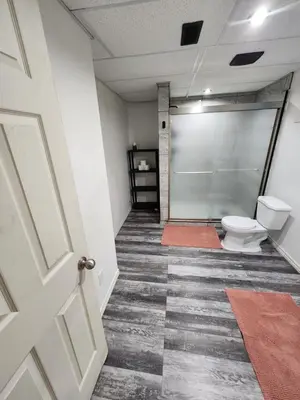 a hallway with a bathroom with a toilet at The Cozy Den in Ingersoll