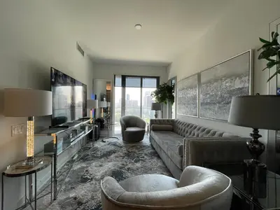 a living room with a couch and a tv at Toronto Bloor & Yonge Luxury Condo in Toronto