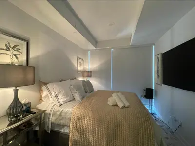 a bedroom with a bed with two towels on it at Toronto Bloor & Yonge Luxury Condo in Toronto