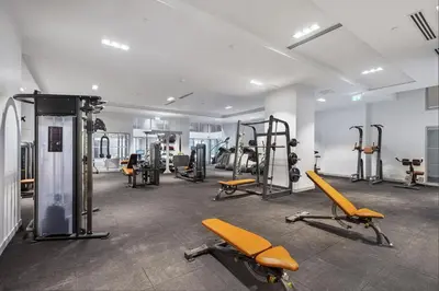 a gym with a lot of treadmills and machines at Toronto Bloor & Yonge Luxury Condo in Toronto