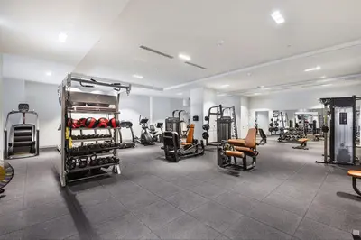 a gym with lots of equipment in a room at Toronto Bloor & Yonge Luxury Condo in Toronto