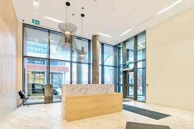 a lobby with a bench in the middle of a building at High Rise 1BR Building w Gorgeous Views in Kitchener