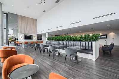 a restaurant with tables and chairs and plants at High Rise 1BR Building w Gorgeous Views in Kitchener