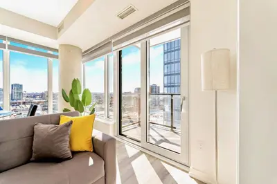 a living room with a couch and large windows at High Rise 1BR Building w Gorgeous Views in Kitchener