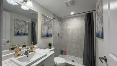 a bathroom with a sink and a toilet and a shower at Ivylea Elegant Luxury Estate Richmond Hill in Richmond Hill