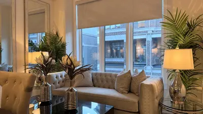 a living room with a couch in front of a window at Ivylea Elegant Luxury Estate Richmond Hill in Richmond Hill