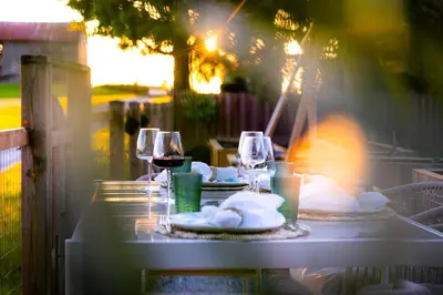 a table with two glasses of wine and napkins at The White House in Caledonia
