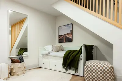 a white bedroom with a bed with a mirror at The White House in Caledonia