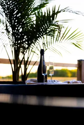 a bottle of wine and a glass on a table at The White House in Caledonia