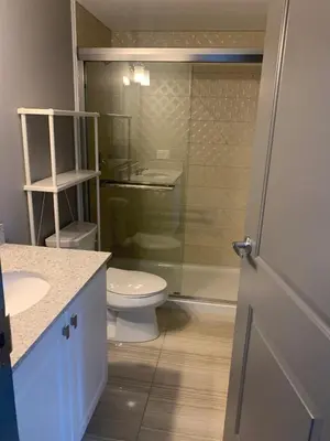 a bathroom with a toilet and a glass shower at Sandy&Kevin#home in Waterloo