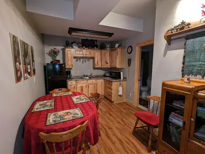 a kitchen with a table in the middle of a room at Stone Ridge Chalet Bed n Breakfast in Dorset