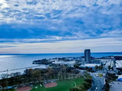 an aerial view of a city next to the water at A lovely one bed room with Sunset Views in Toronto