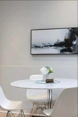 a white dining room with a white table and chairs at Casa Queen - Unique 2BR Suite in Leslieville in Toronto