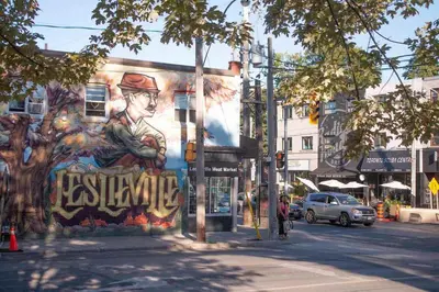 a mural on the side of a building on a street at Casa Queen East - Modern 2BR Suite in Leslieville in Toronto