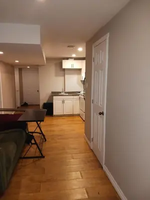 a living room with a table and a kitchen at Cheap Rooms in Kitchener Best For Students ,Long Term Guests in Kitchener