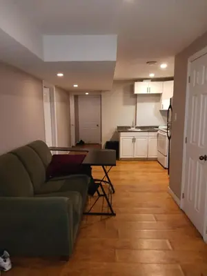 a living room with a couch and a kitchen at Cheap Rooms in Kitchener Best For Students ,Long Term Guests in Kitchener