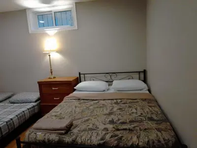 a bedroom with two beds and a dresser and a window at Cheap Rooms in Kitchener Best For Students ,Long Term Guests in Kitchener