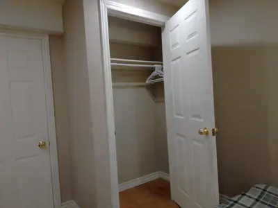 a bedroom with a closet with a white door at Cheap Rooms in Kitchener Best For Students ,Long Term Guests in Kitchener
