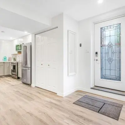 a kitchen with white walls and a window and a refrigerator at Beautiful Apartment 5 mins from Innisfil Beach in Innisfil