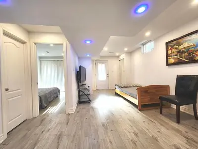 a bedroom with a bed and a desk and a television at Cozy Walkout Suite in Vaughan