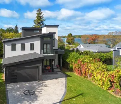 a large white house with a driveway at The Lake House in Georgina