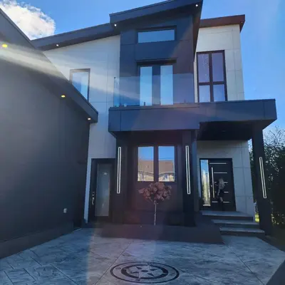 a house with a glass facade with a driveway at The Lake House in Georgina