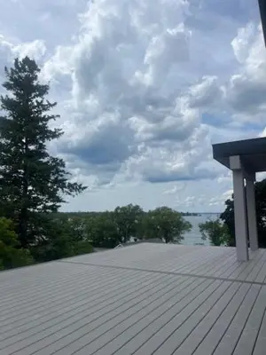 a wooden deck with a view of the water at The Lake House in Georgina