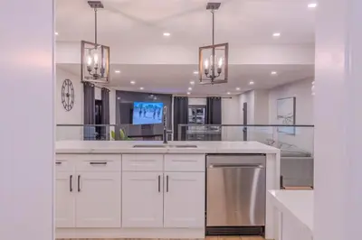a kitchen with white cabinets and stainless steel appliances at 6 Bedroom Modern Escape in Horseshoe, Pool and Hot tub in Coldwater