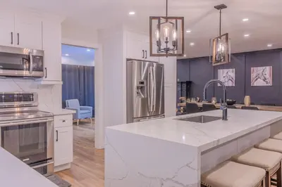 a kitchen with a white counter top and a refrigerator at 6 Bedroom Modern Escape in Horseshoe, Pool and Hot tub in Coldwater