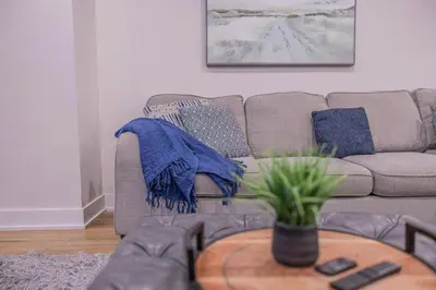 a living room with a couch and a table at 6 Bedroom Modern Escape in Horseshoe, Pool and Hot tub in Coldwater
