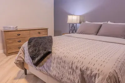 a bedroom with a large bed and a dresser at 6 Bedroom Modern Escape in Horseshoe, Pool and Hot tub in Coldwater