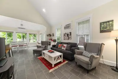 a living room with couches and chairs and a table at The Firefly - 6 Chipmunk in Cherry Valley
