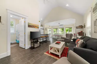 a living room with a couch and a tv at The Firefly - 6 Chipmunk in Cherry Valley