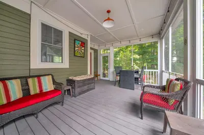 a screened porch with two chairs and a table at The Jack Pine - 50 Hollow in Cherry Valley