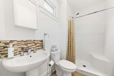 a white bathroom with a sink and a toilet at The Jack Pine - 50 Hollow in Cherry Valley