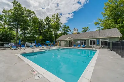 a swimming pool in front of a house at The Jack Pine - 50 Hollow in Cherry Valley
