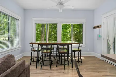 a dining room with a table and some chairs at The Jack Pine - 50 Hollow in Cherry Valley