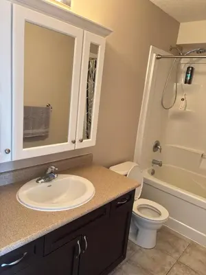 a bathroom with a sink and a toilet at 2 beds suit in Kitchener