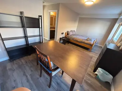 a living room with a wooden table and a couch at 2 beds suit in Kitchener