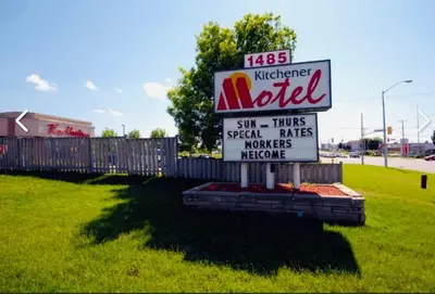 a sign for a motel in a field at Kitchener Motel in Kitchener