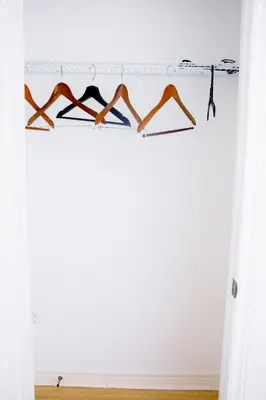 a rack of clothes hanging in a room at Cozy relaxation haven 1 Bedroom basement in London