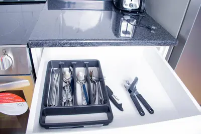 a tray of utensils sitting on top of a counter at Cozy relaxation haven 1 Bedroom basement in London