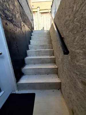a stairway leading up to a building with a stair railing at Cozy relaxation haven 1 Bedroom basement in London