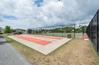a tennis court with a net on a court at The Kiskadee - 49 Butternut in Cherry Valley